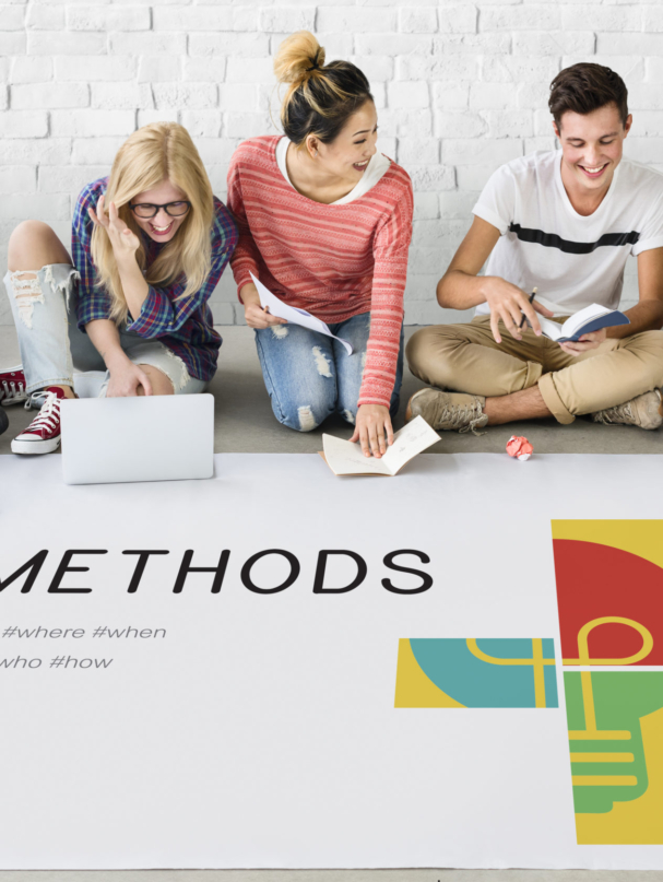 Group of students working on laptop network graphic overlay on the floor